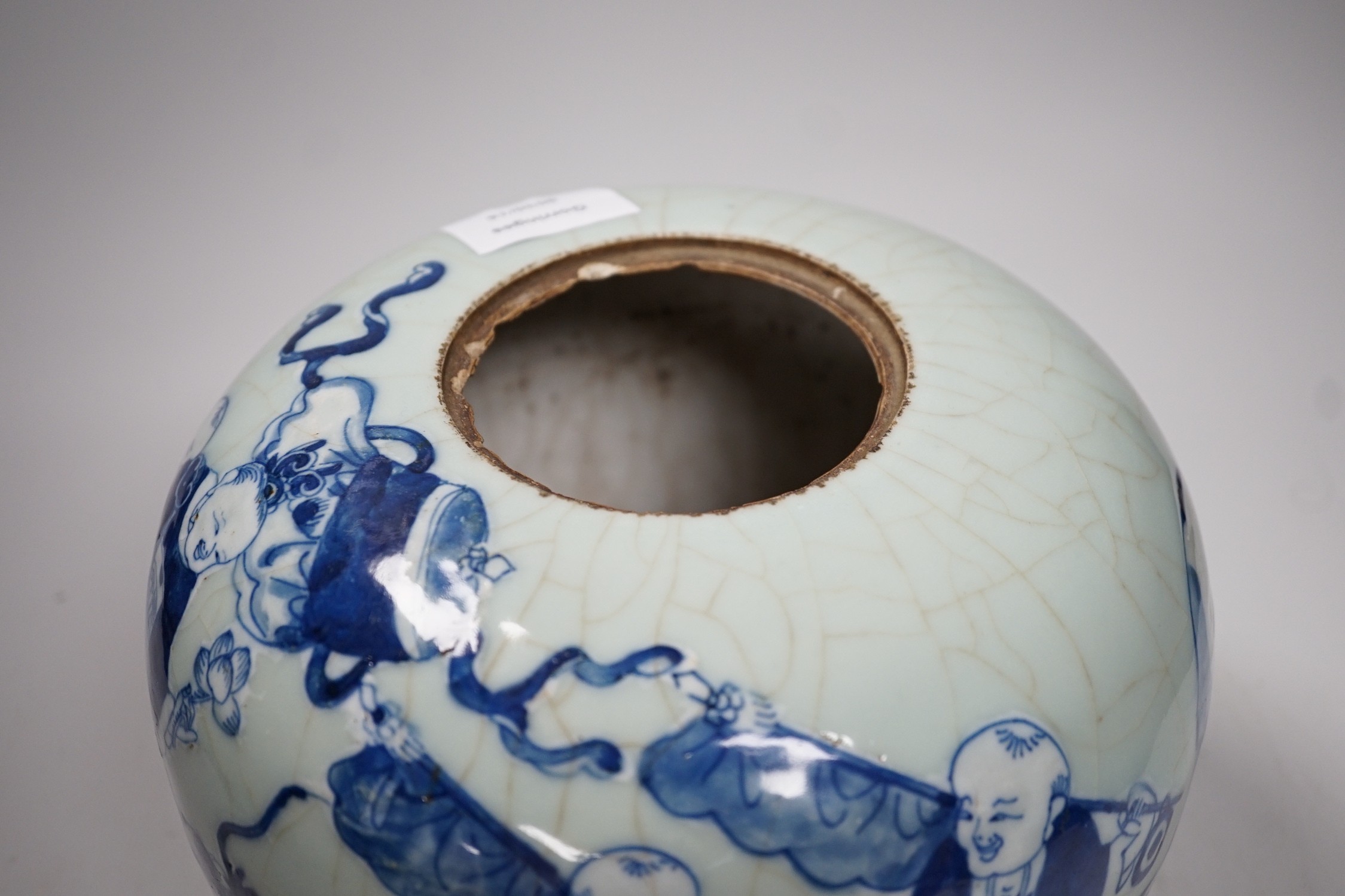 A Chinese underglaze blue and slip decorated celadon crackle glazed vase and associated cover, late Qing dynasty, 21cms high